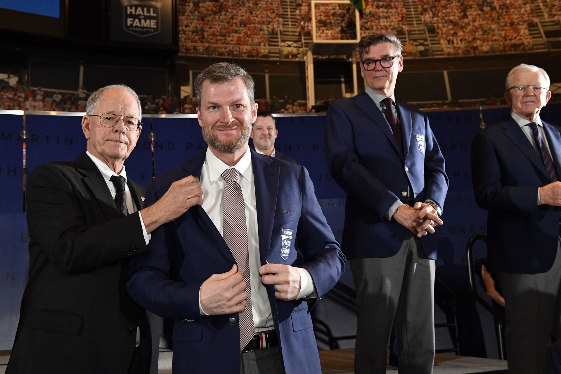 NASCAR CEO Jim France presents Dale Earnhardt Jr. with his jacket during the 2021 NHOF. Source: Getty
